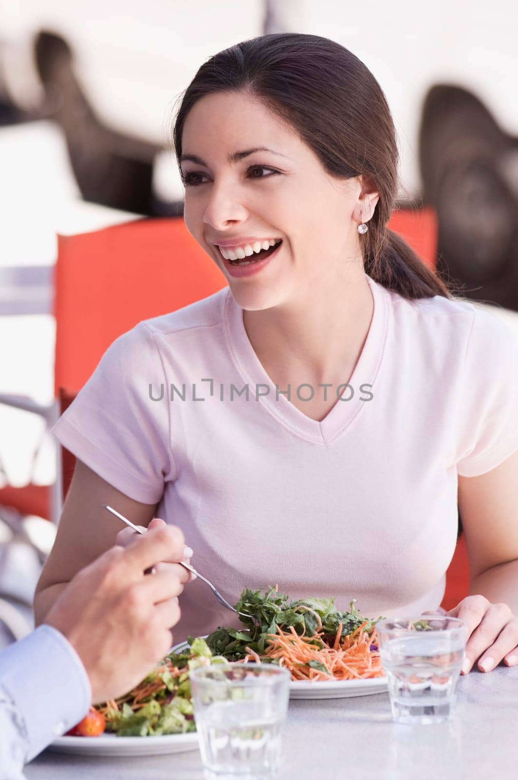 Close_up of a woman eating salad in a restaurant