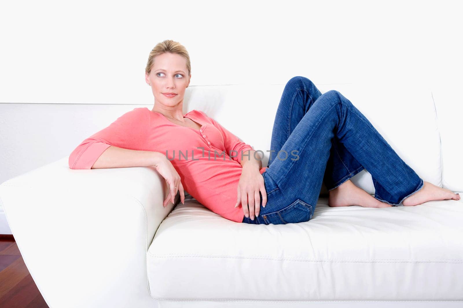 Woman reclining on a couch and day dreaming