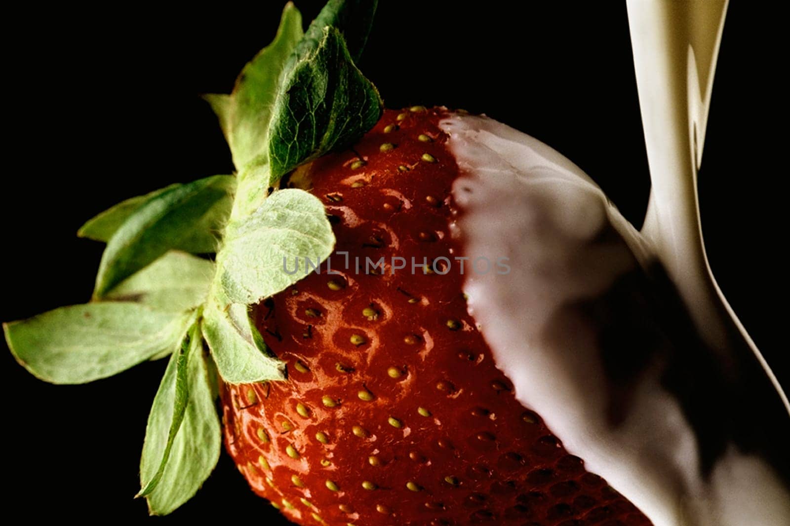 Close_up of cream being poured on a strawberry