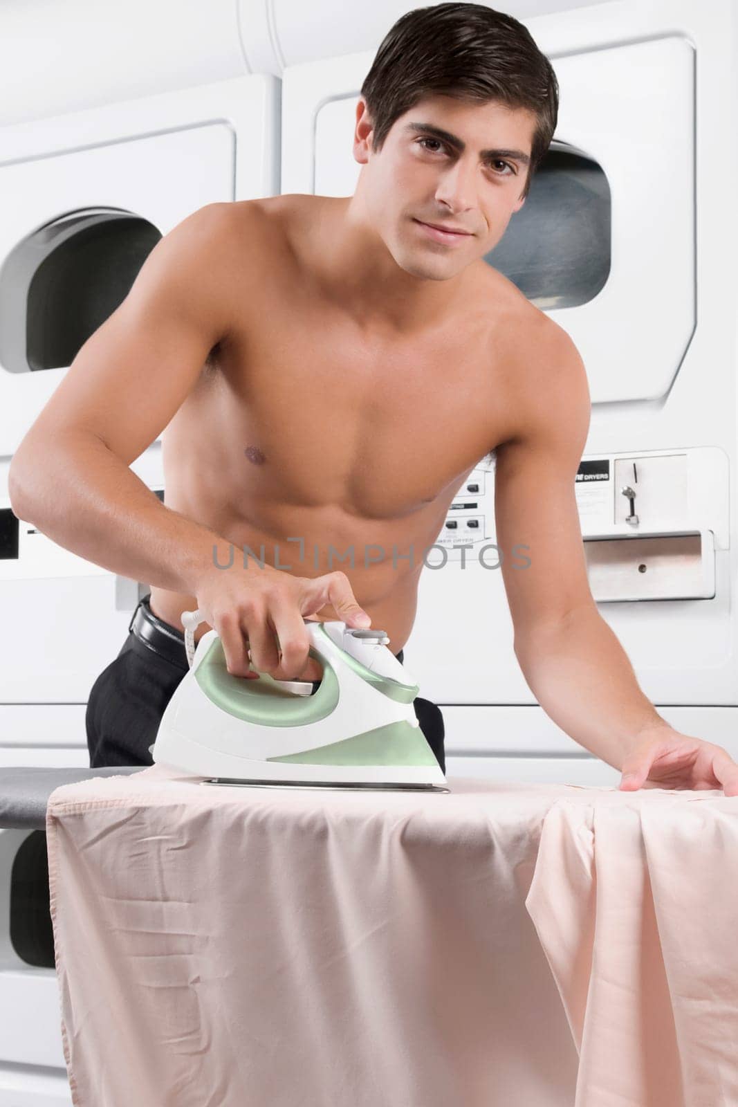 Portrait of a man ironing a shirt