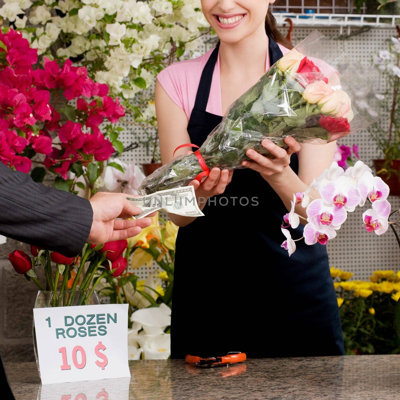 Customer giving cash payment to a female florist