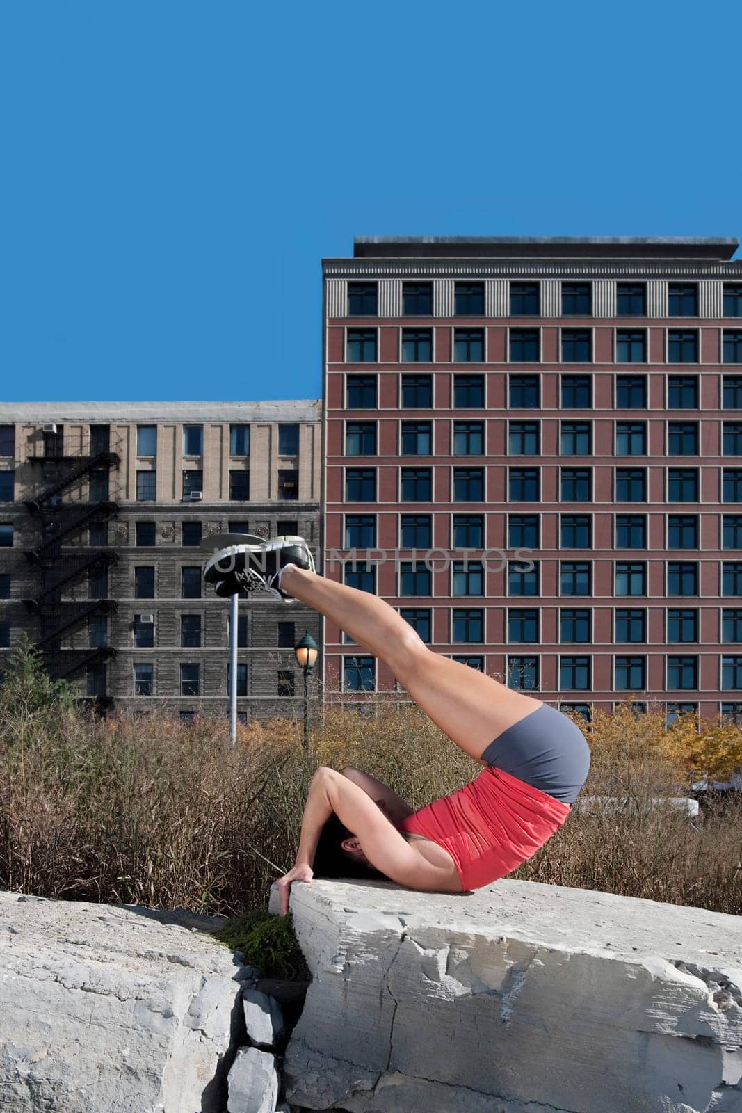 Woman exercising on a stone