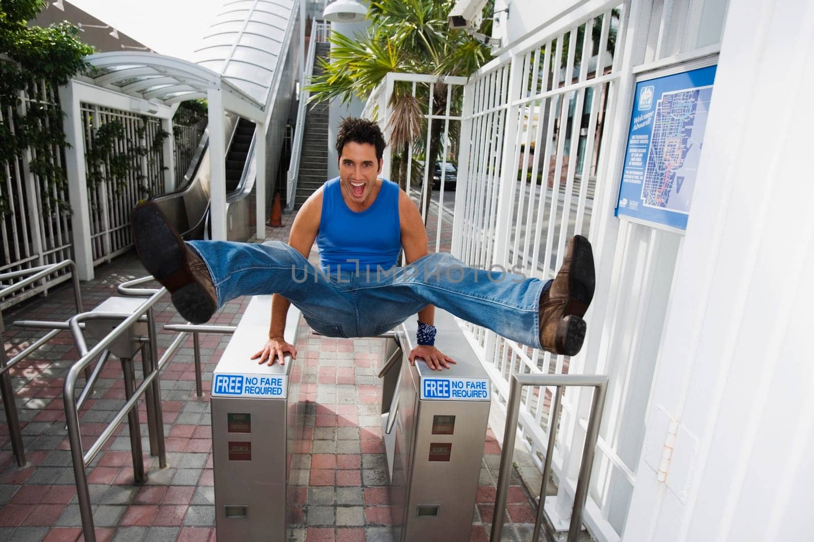 Young man jumping over the ticket barriers