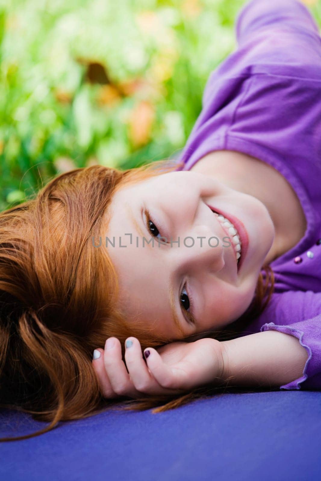 Portrait of a girl lying down and smiling