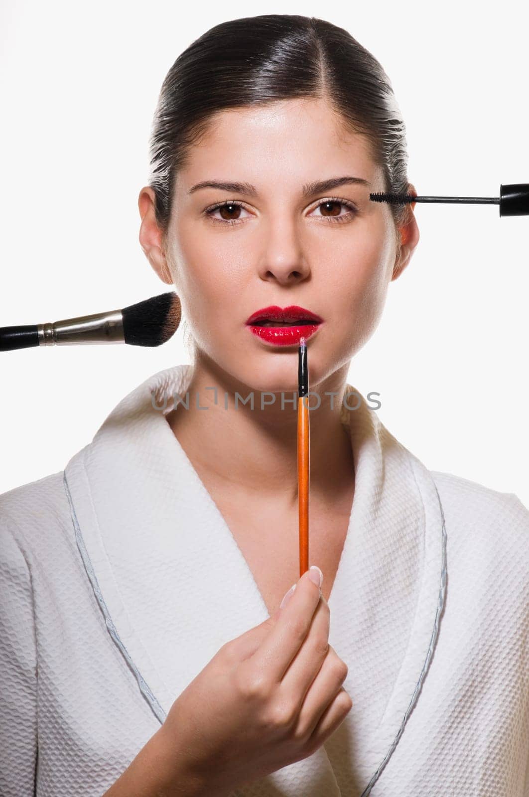 Portrait of a young woman applying make_up