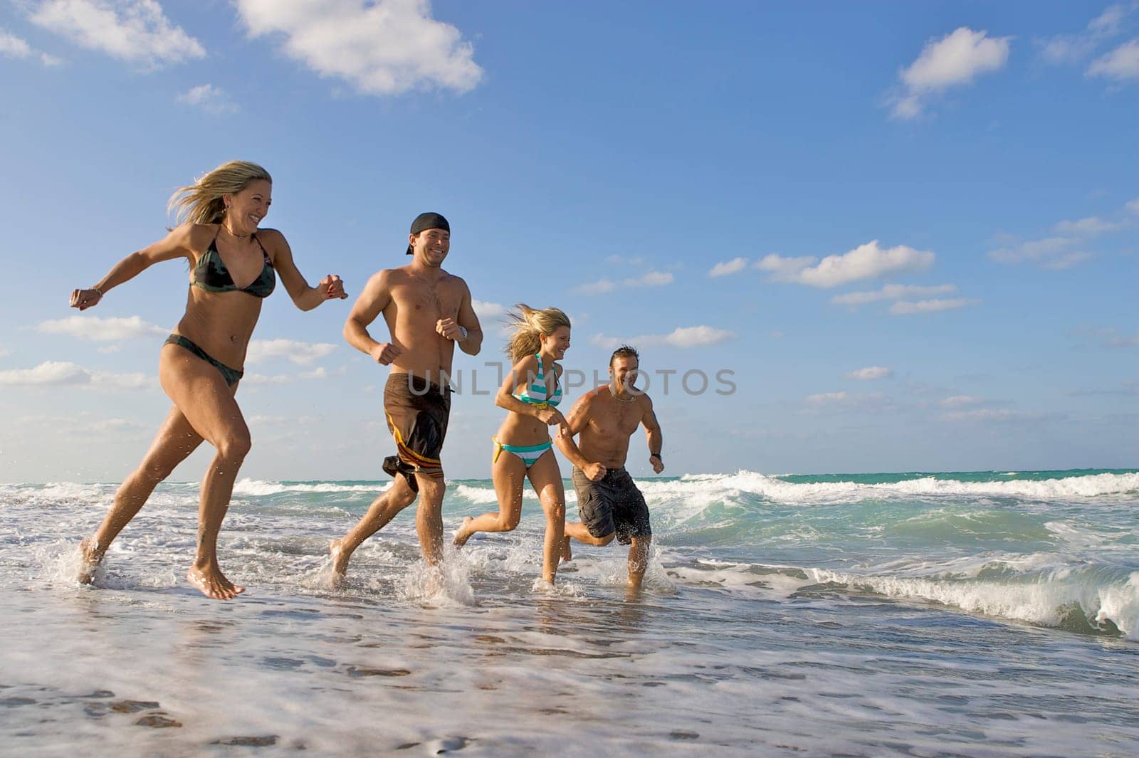 Couples running on the beach