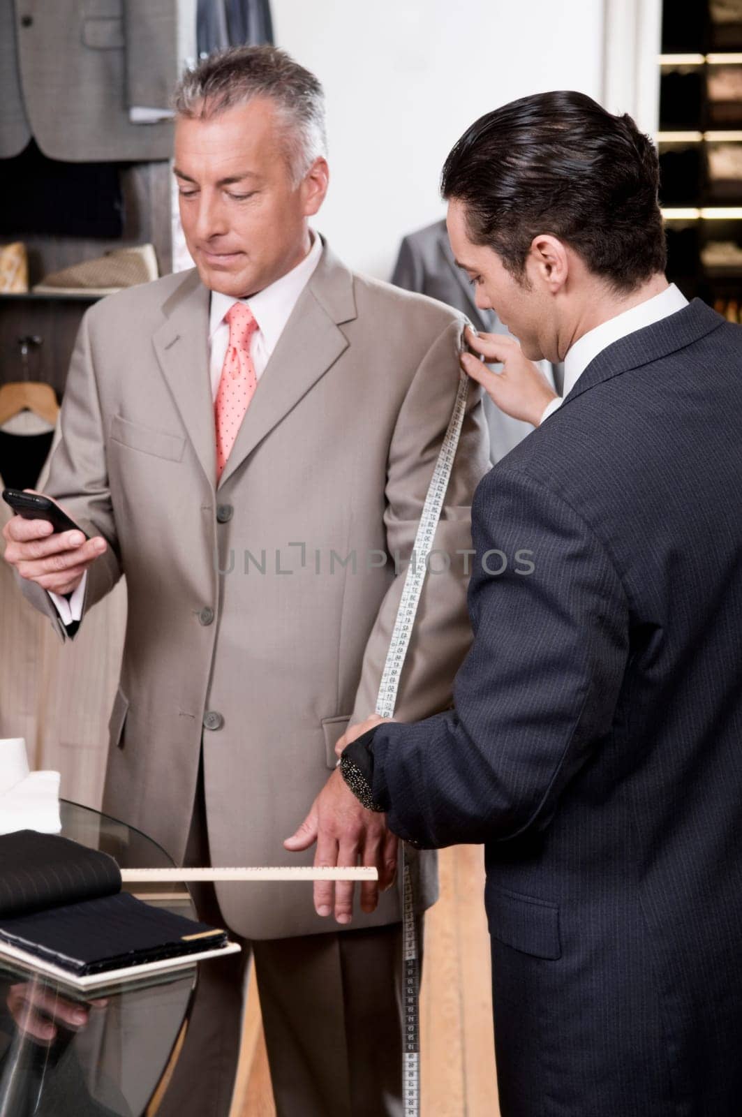 Tailor taking the measurements of a customer