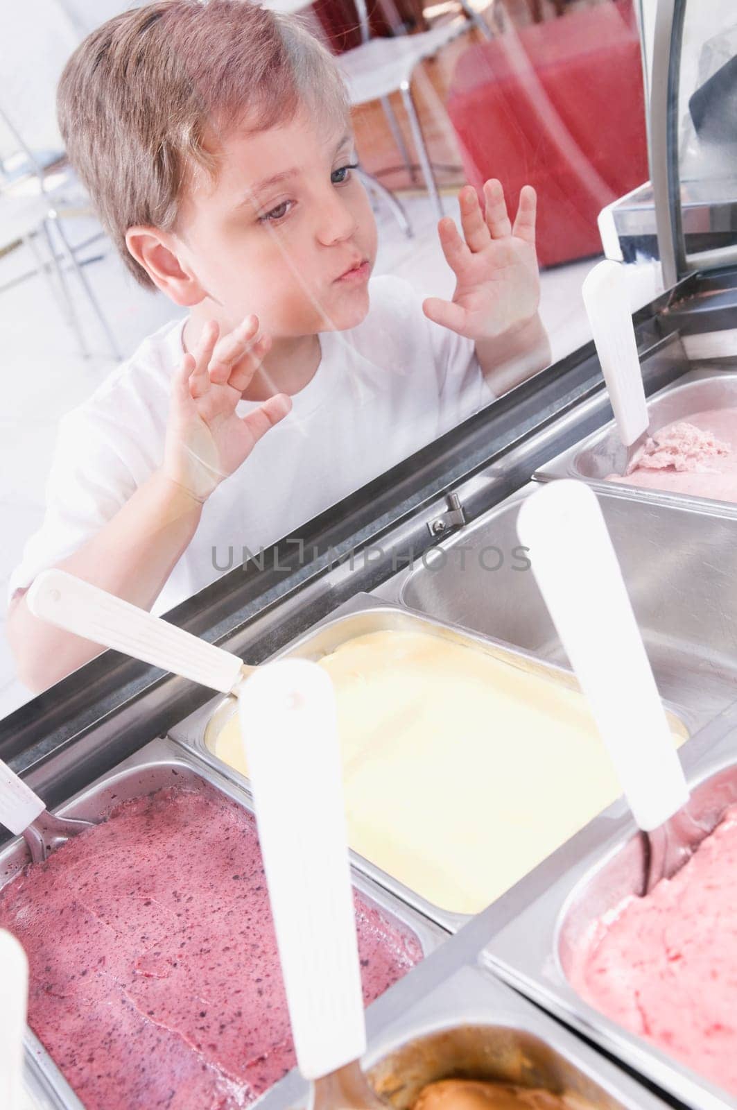 Boy choosing ice cream in an ice cream parlor