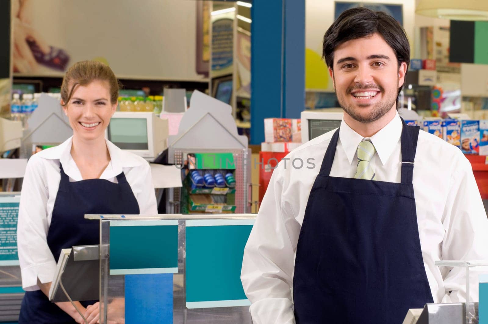 Sales clerks smiling in a supermarket