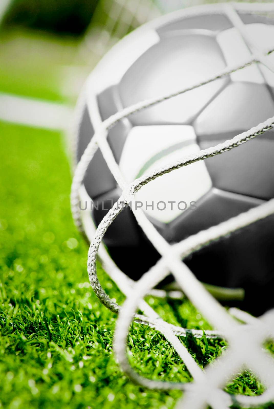 Close_up of a soccer ball in the net