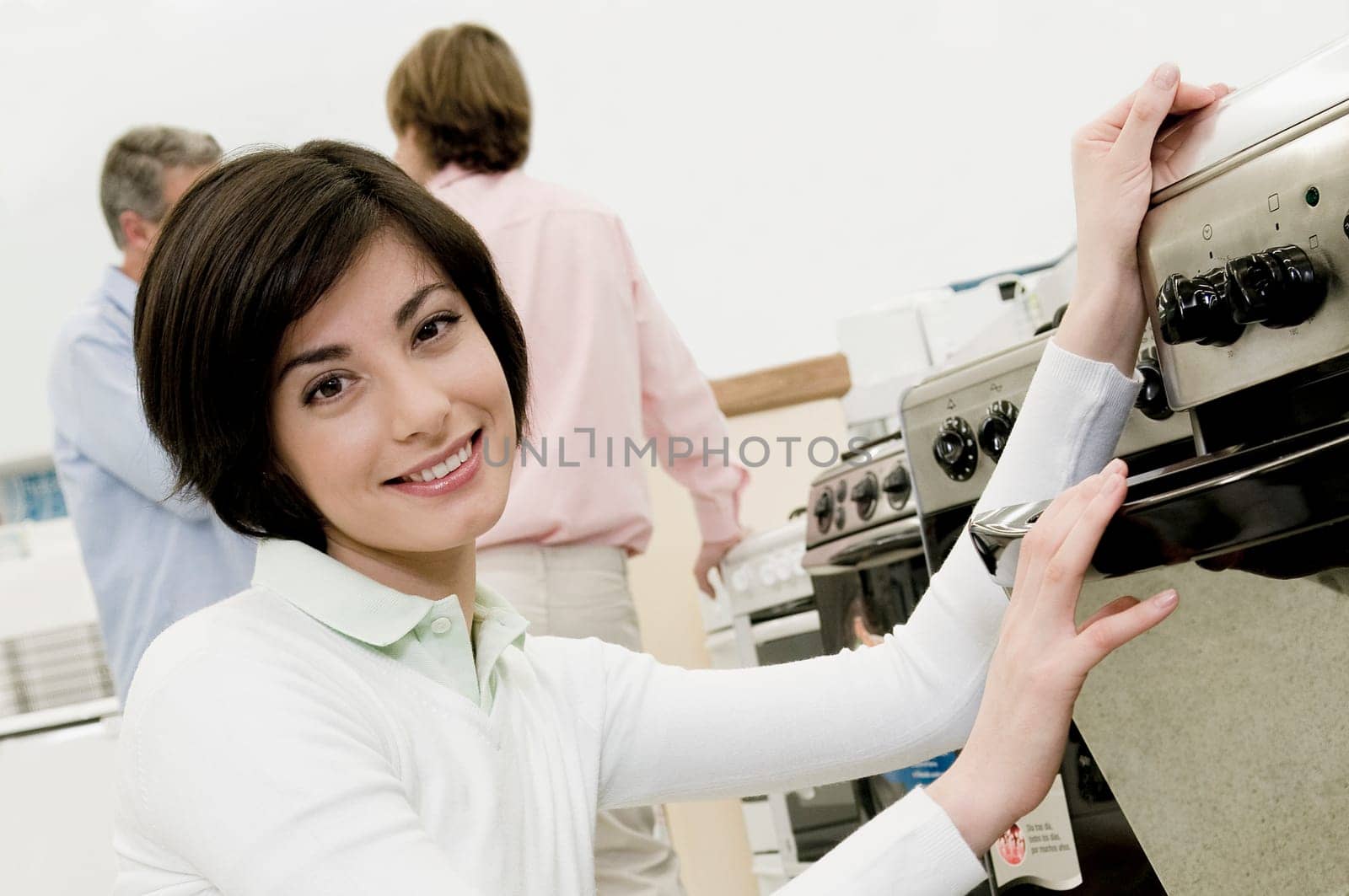 Female sales clerk showing a gas range