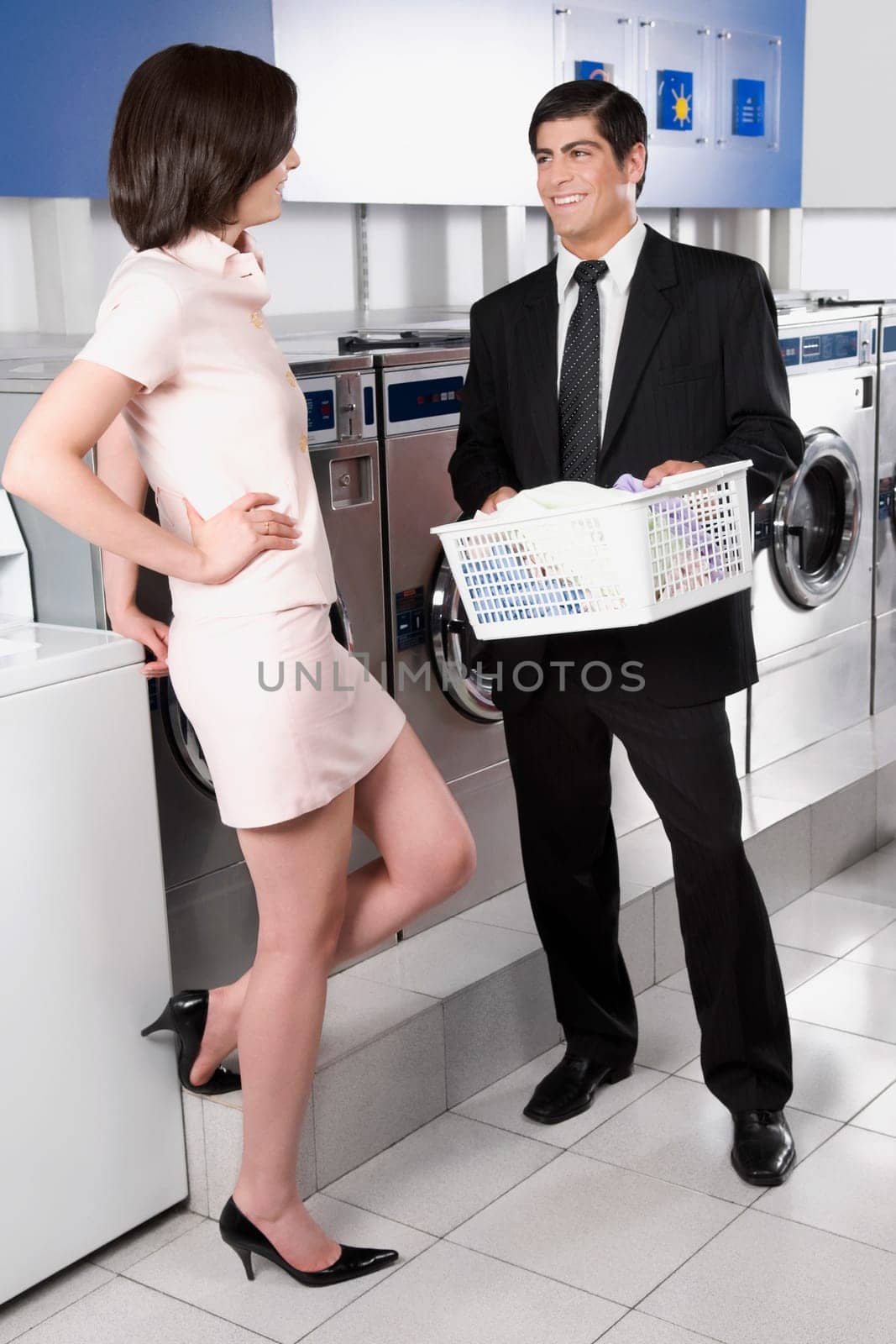 Couple talking to each other in a laundromat