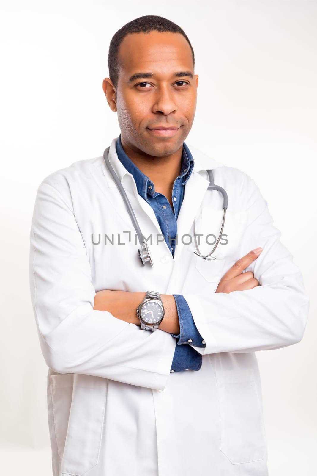 Handsome young african doctor posing isolated over a white background