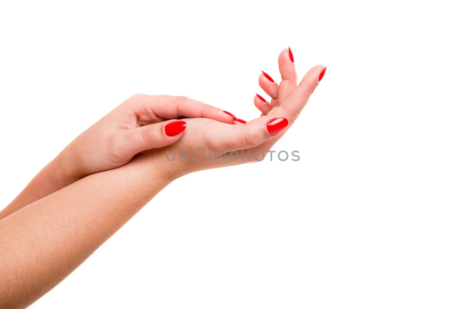 Delicate and well-manicured hands being massaged and rubbed together
