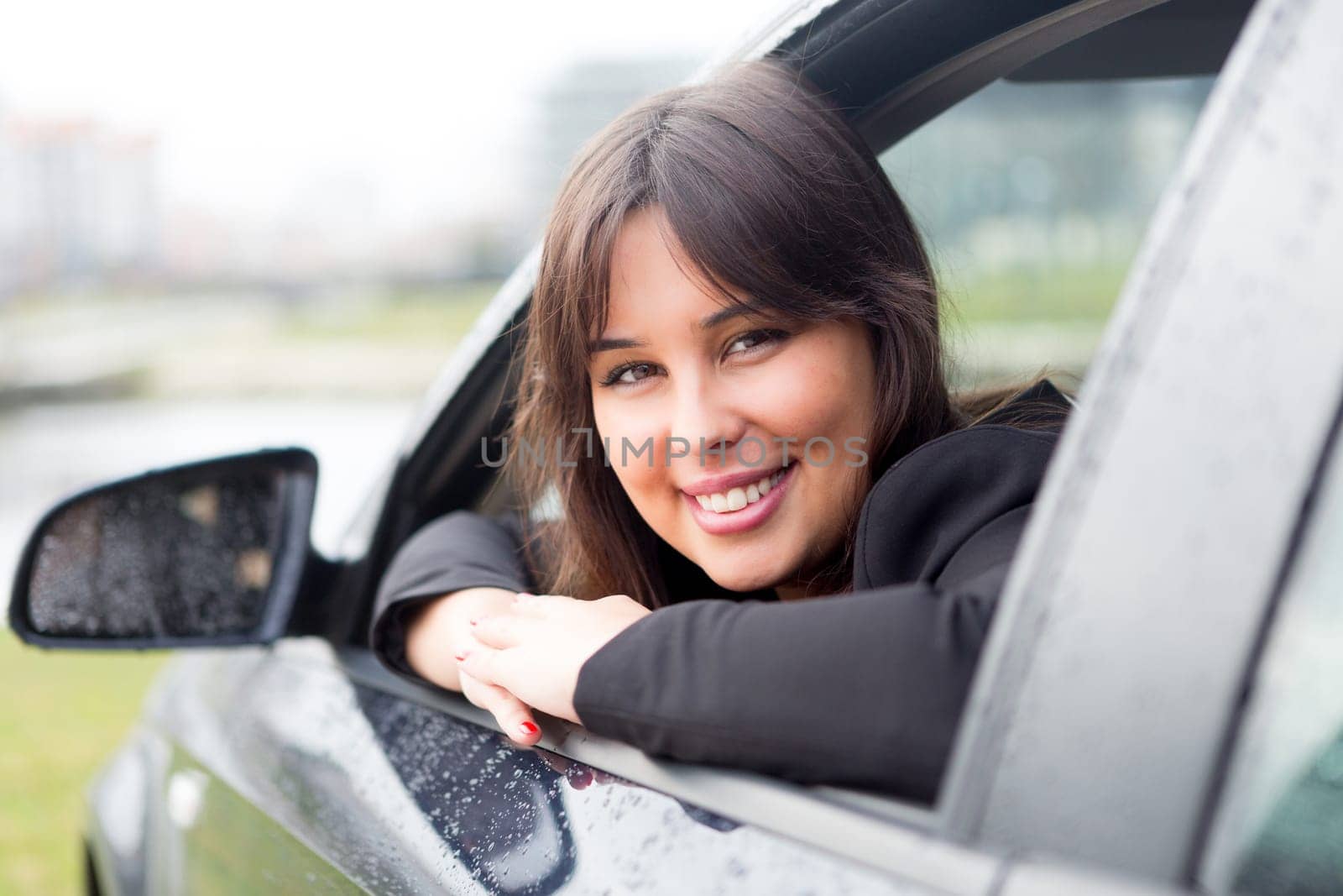 Business woman driving her new sports car