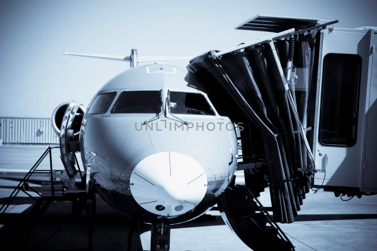 Airplane attached to passenger boarding bridge at an airport