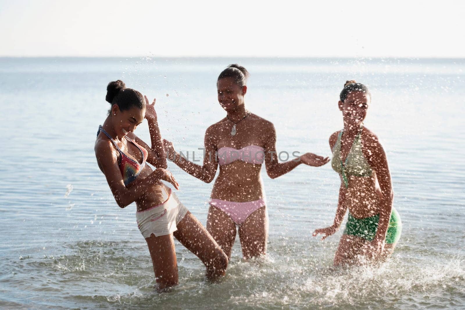 Teenage girl with her friends having fun on the beach