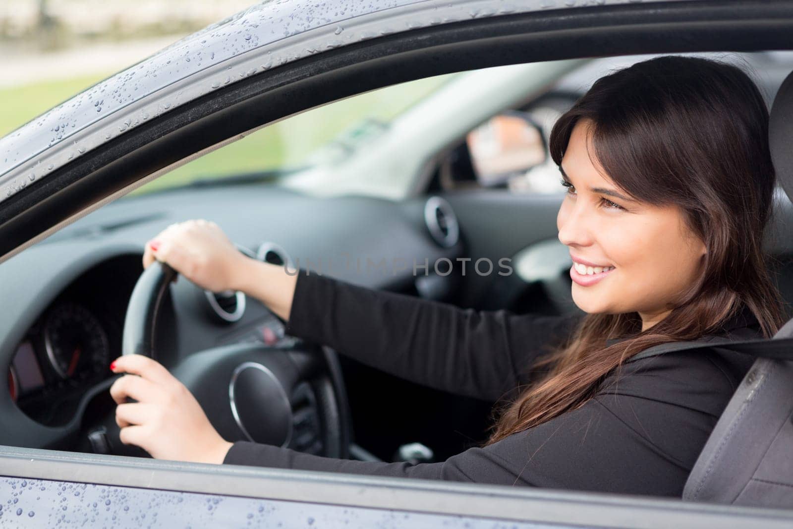 Business woman driving her new sports car