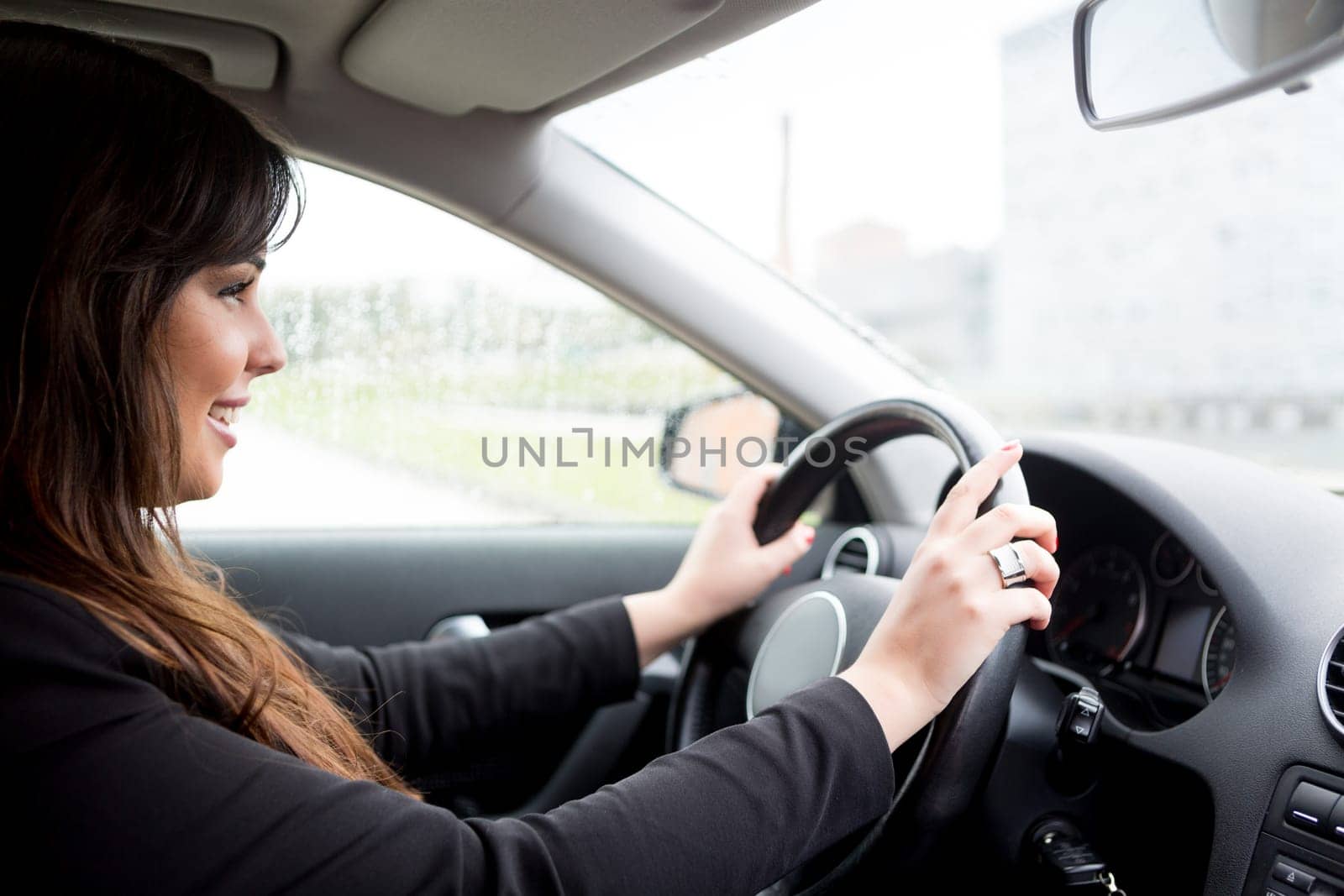 Business woman driving her new sports car