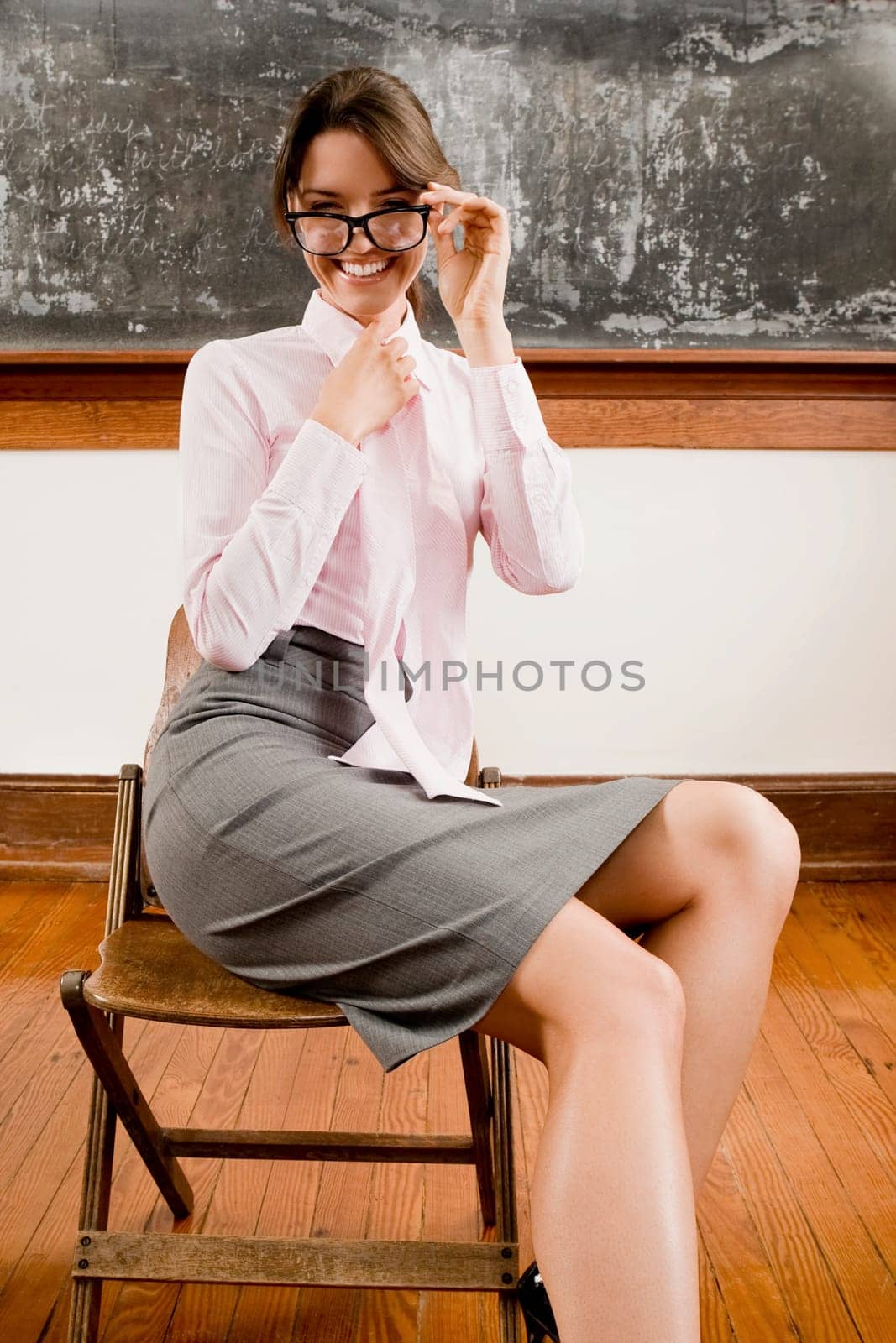 Female teacher sitting on a chair and smiling