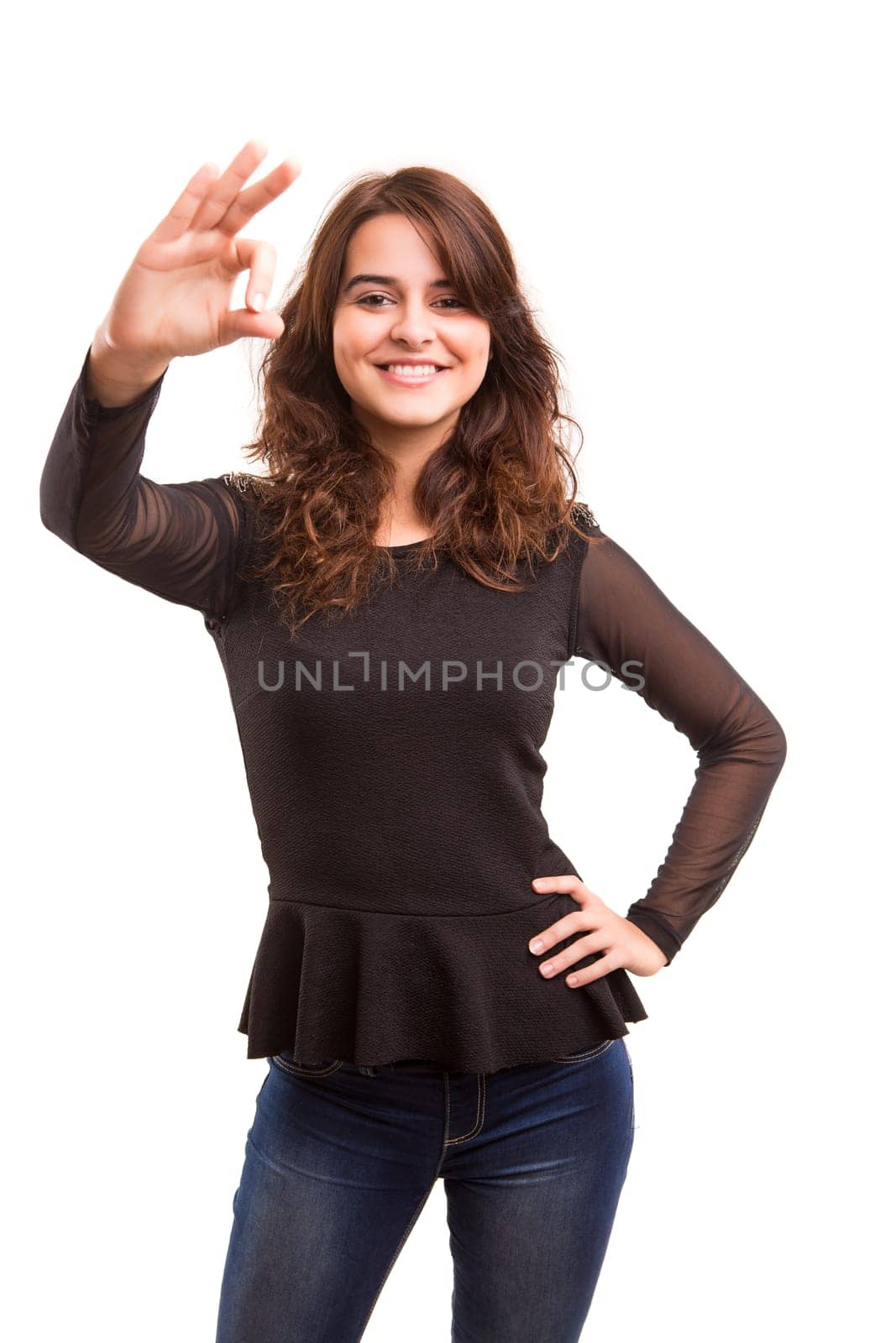 Beautiful young woman signaling ok, isolated over white