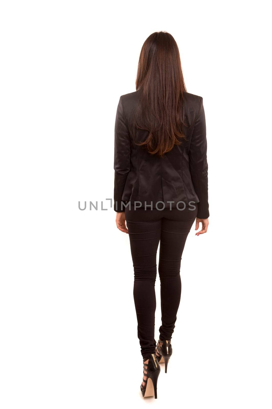 Businesswoman posing with her back faced to camera, isolated over copy space background