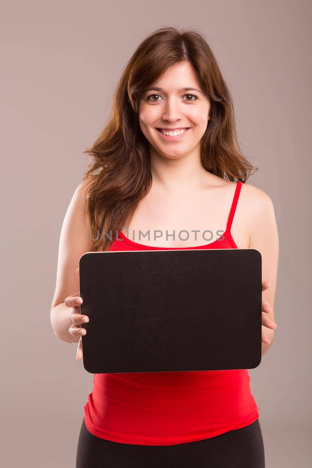 Young beautiful woman holding a small black board