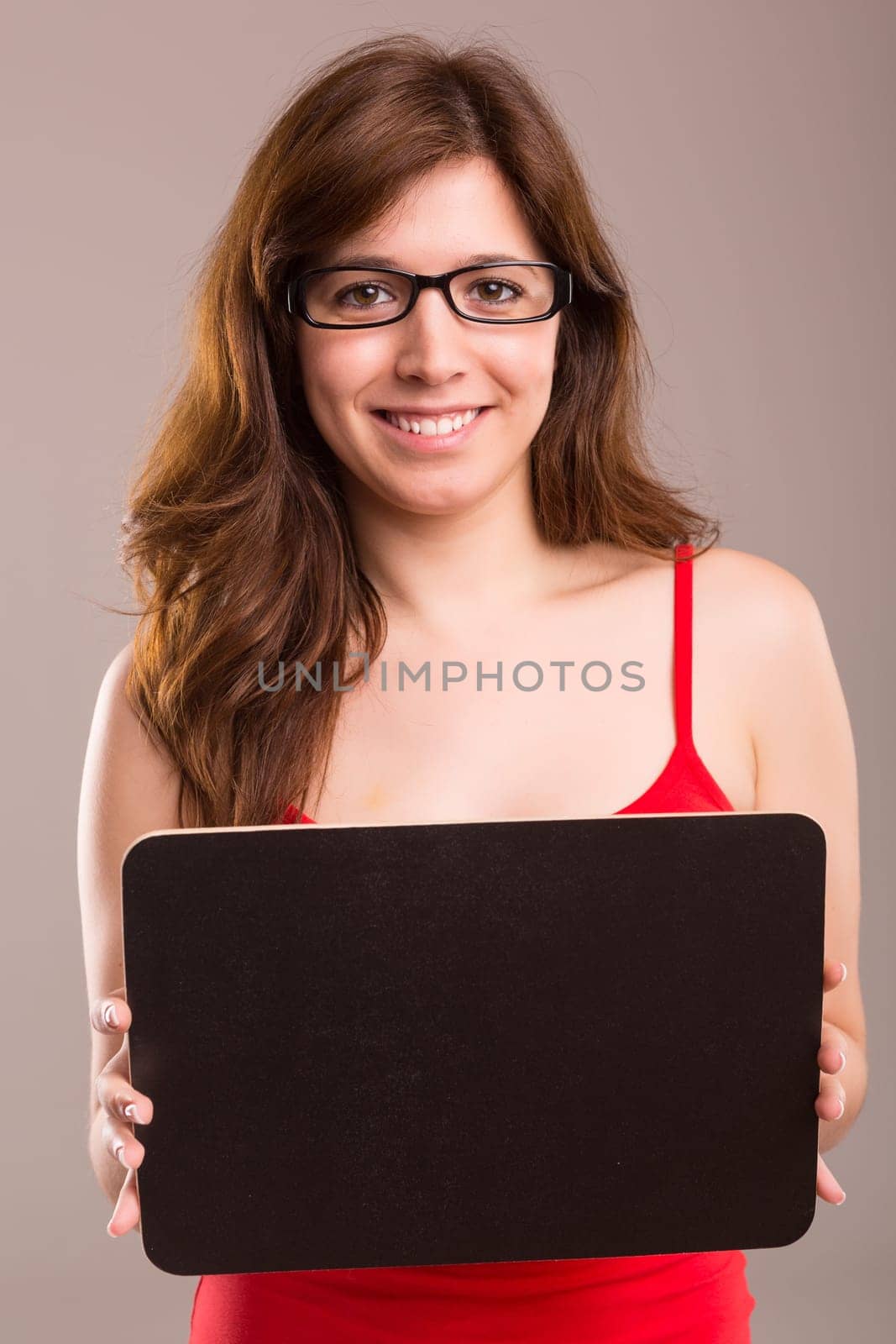 Young beautiful woman holding a small black board