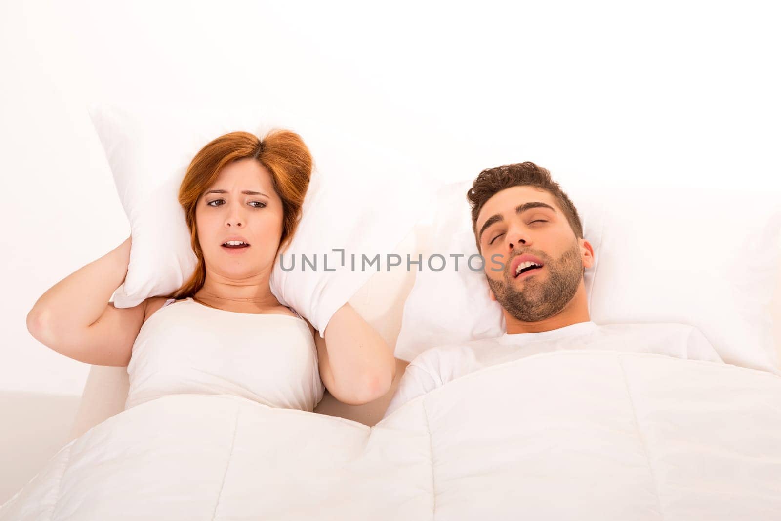 Portrait of an annoyed woman awaken by her fiance's snoring