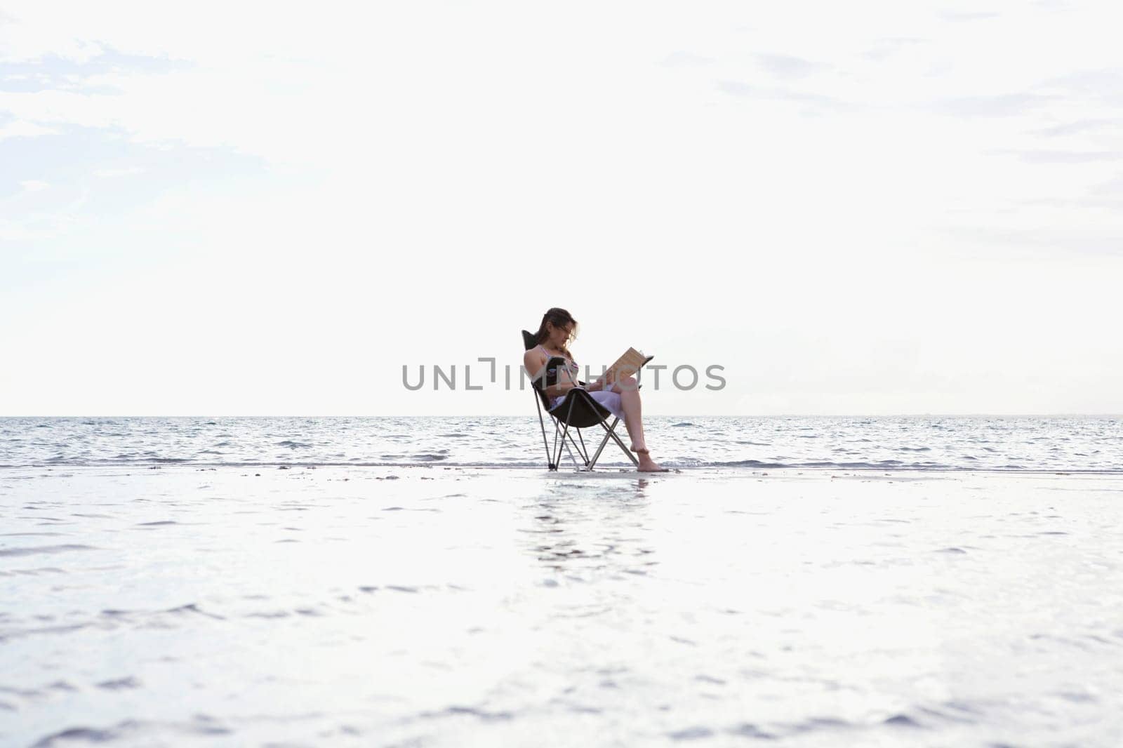 Side profile of a young woman sitting in a folding chair