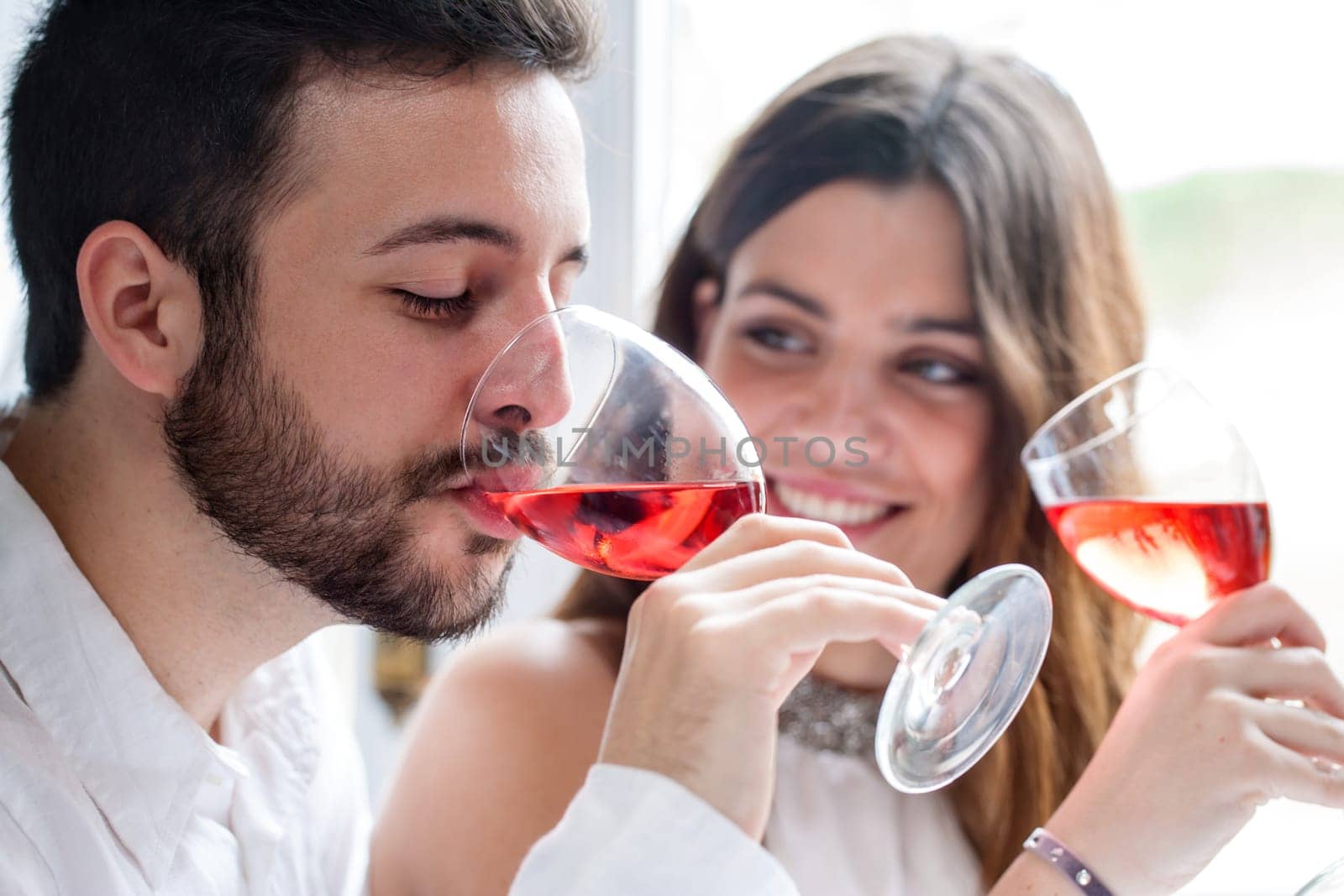 Close up portrait of Couple enjoying and drinking wine at tasting.