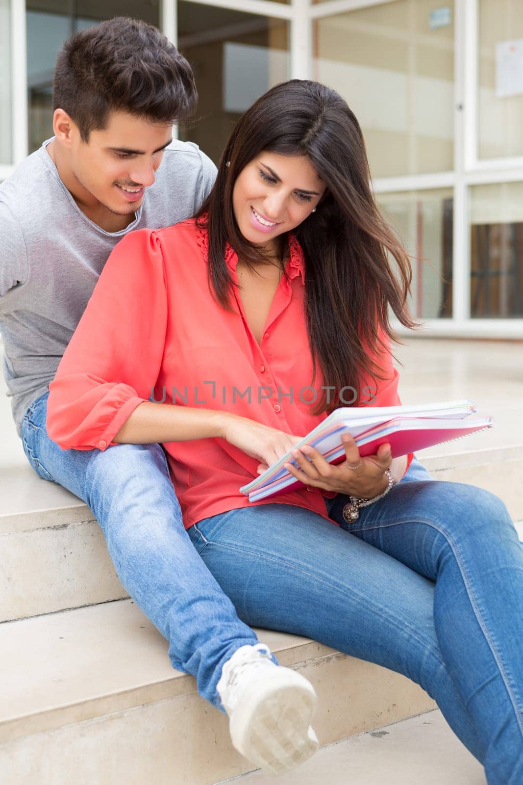 Couple of happy students at the university campus