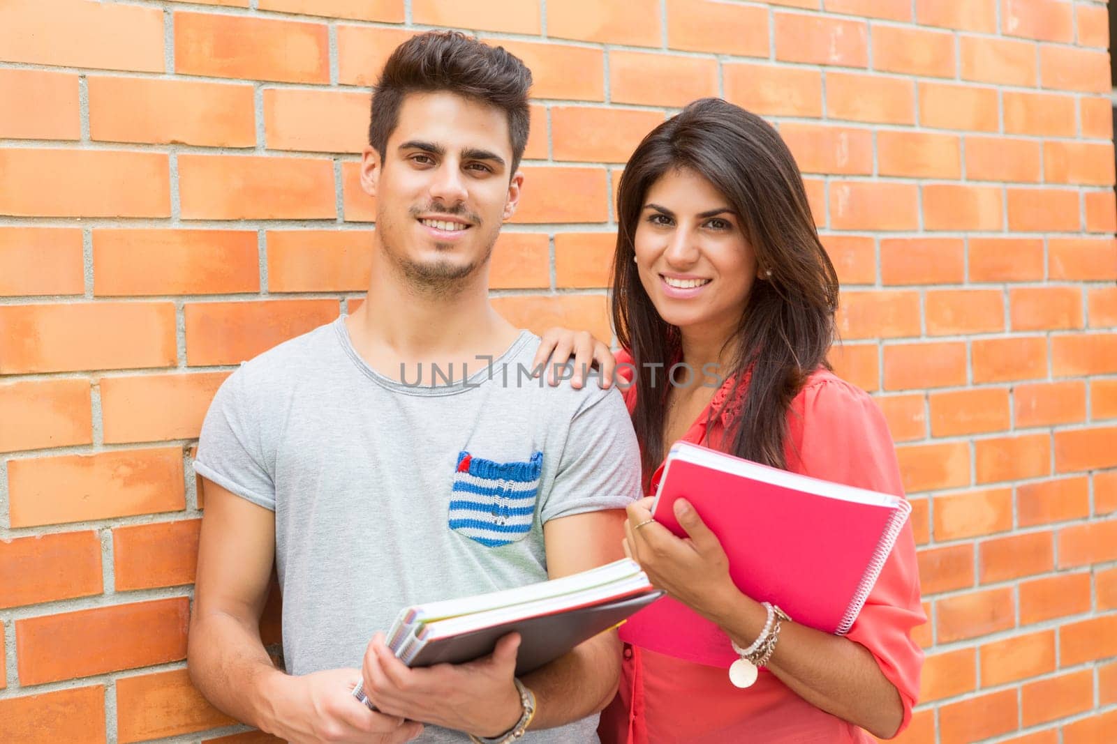 Couple of happy students at the university campus