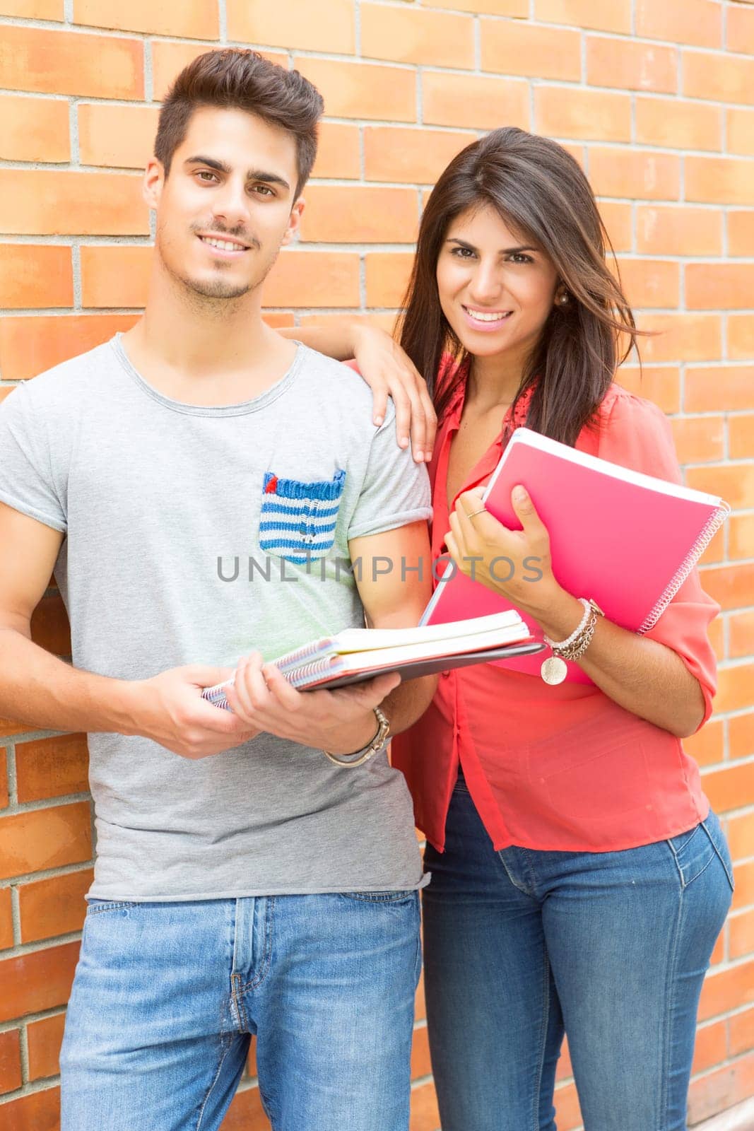 Couple of happy students at the university campus