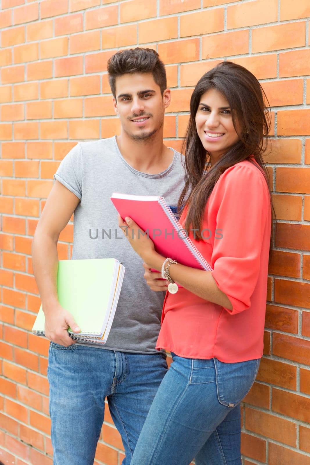 Couple of happy students at the university campus