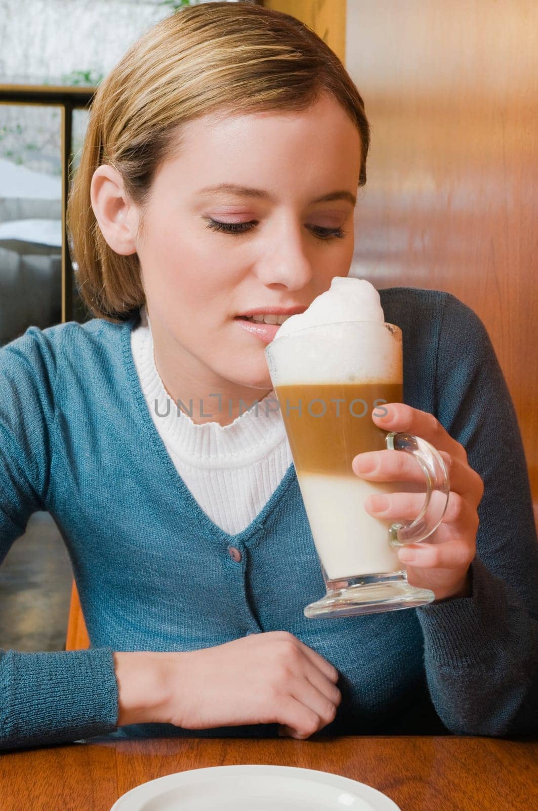 Young woman drinking cappuccino