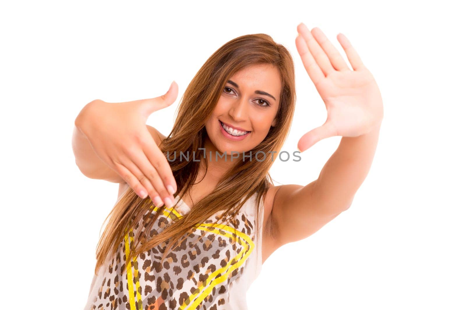 Happy teenager wearing braces, posing isolated over a white background