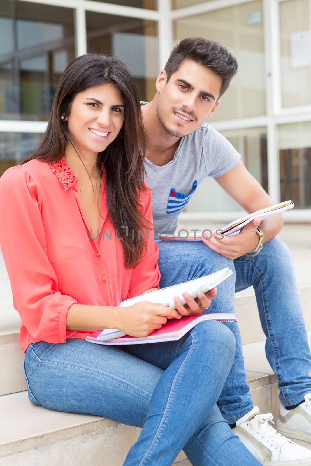 Couple of happy students at the university campus