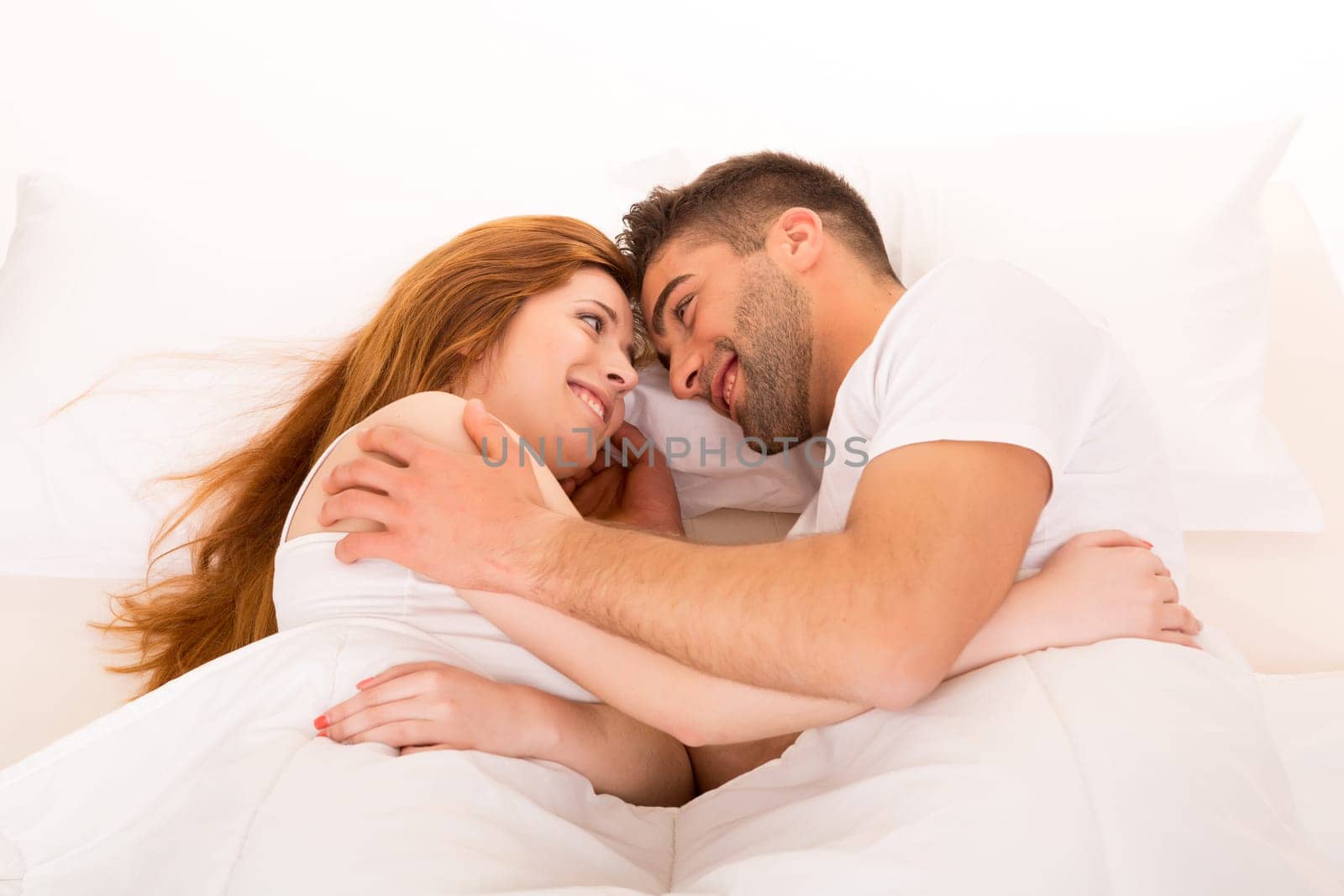A beautiful young passionate couple in bed
