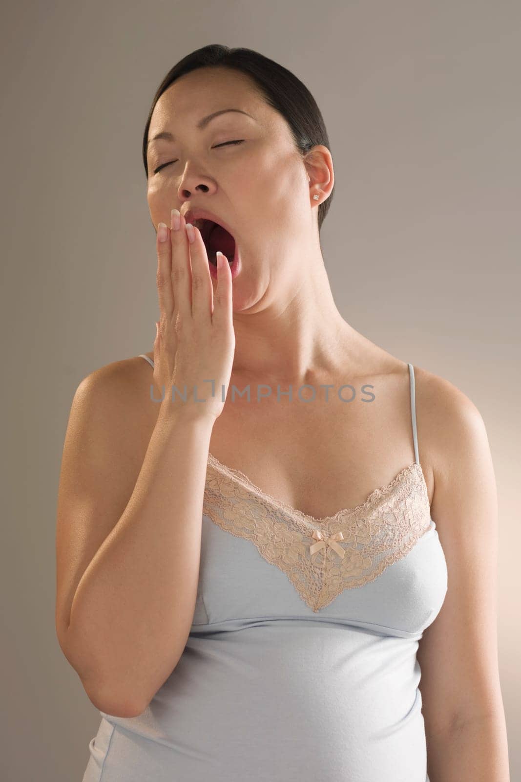 Close_up of a pregnant woman yawning