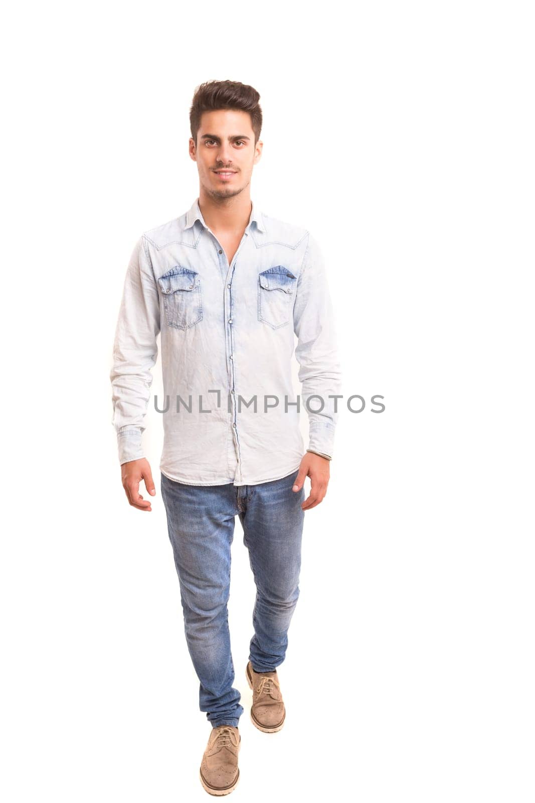 Studio picture of a young and handsome man posing isolated