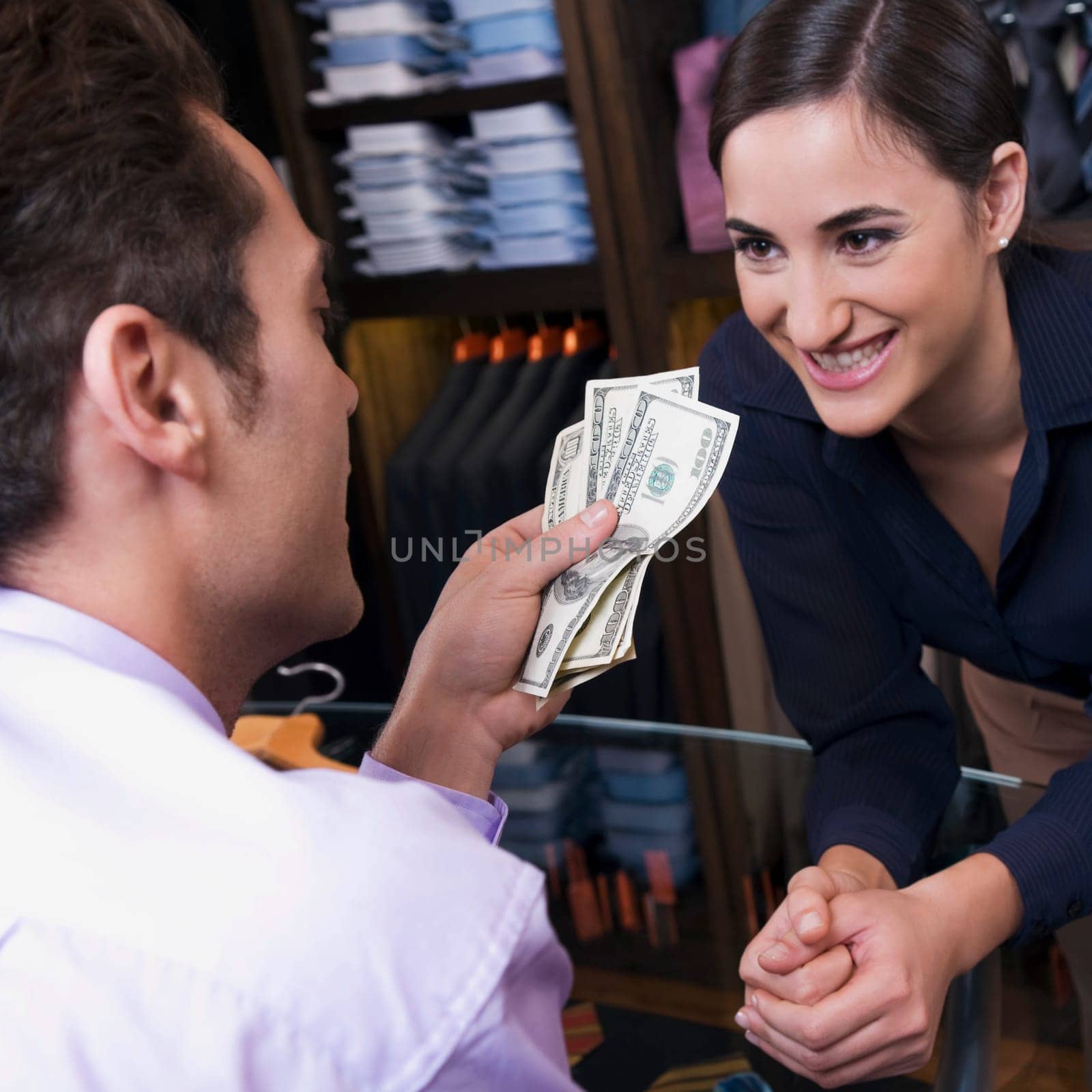 Man paying to a sales clerk in a clothing store