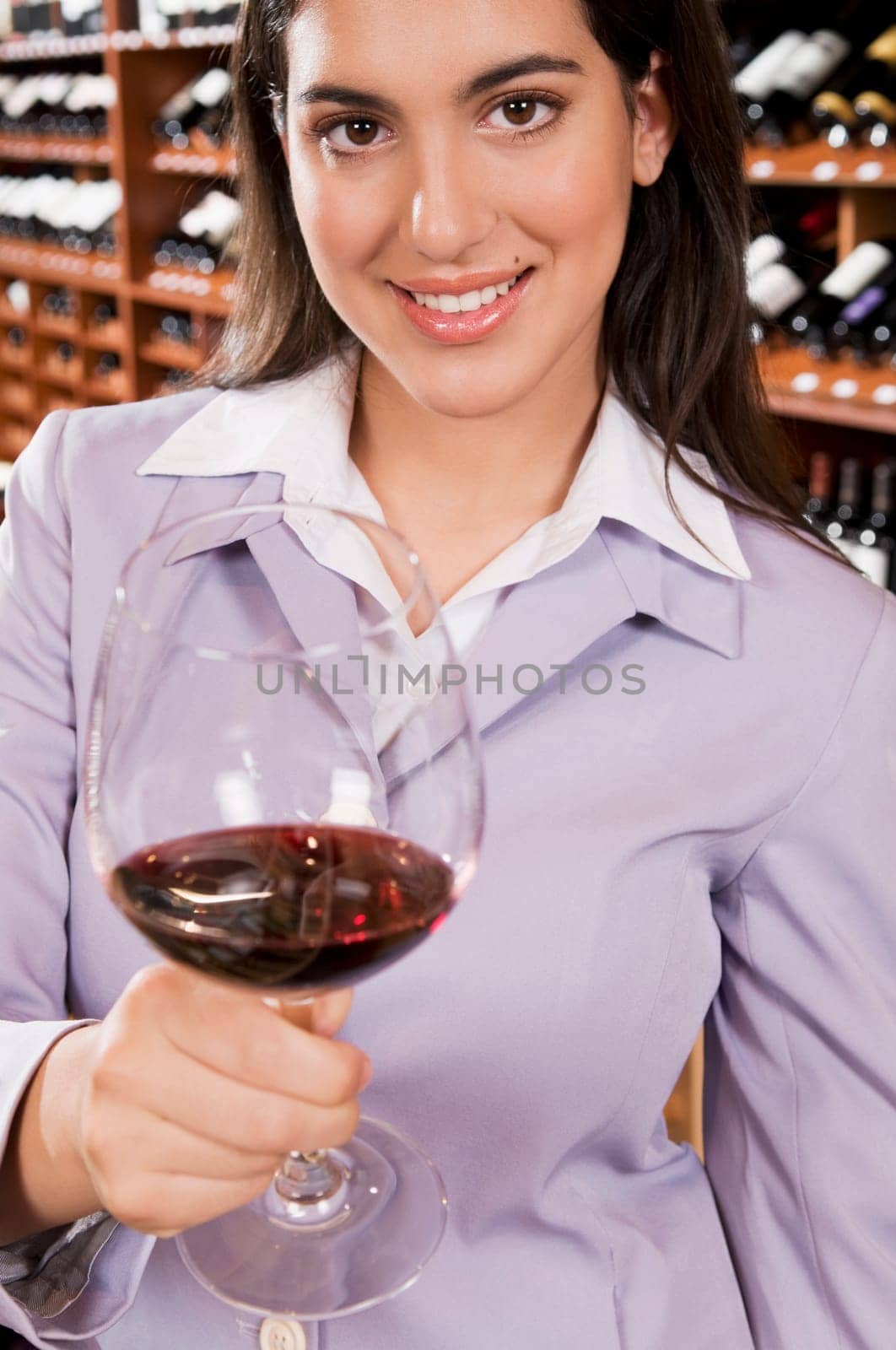 Businesswoman holding a glass of wine