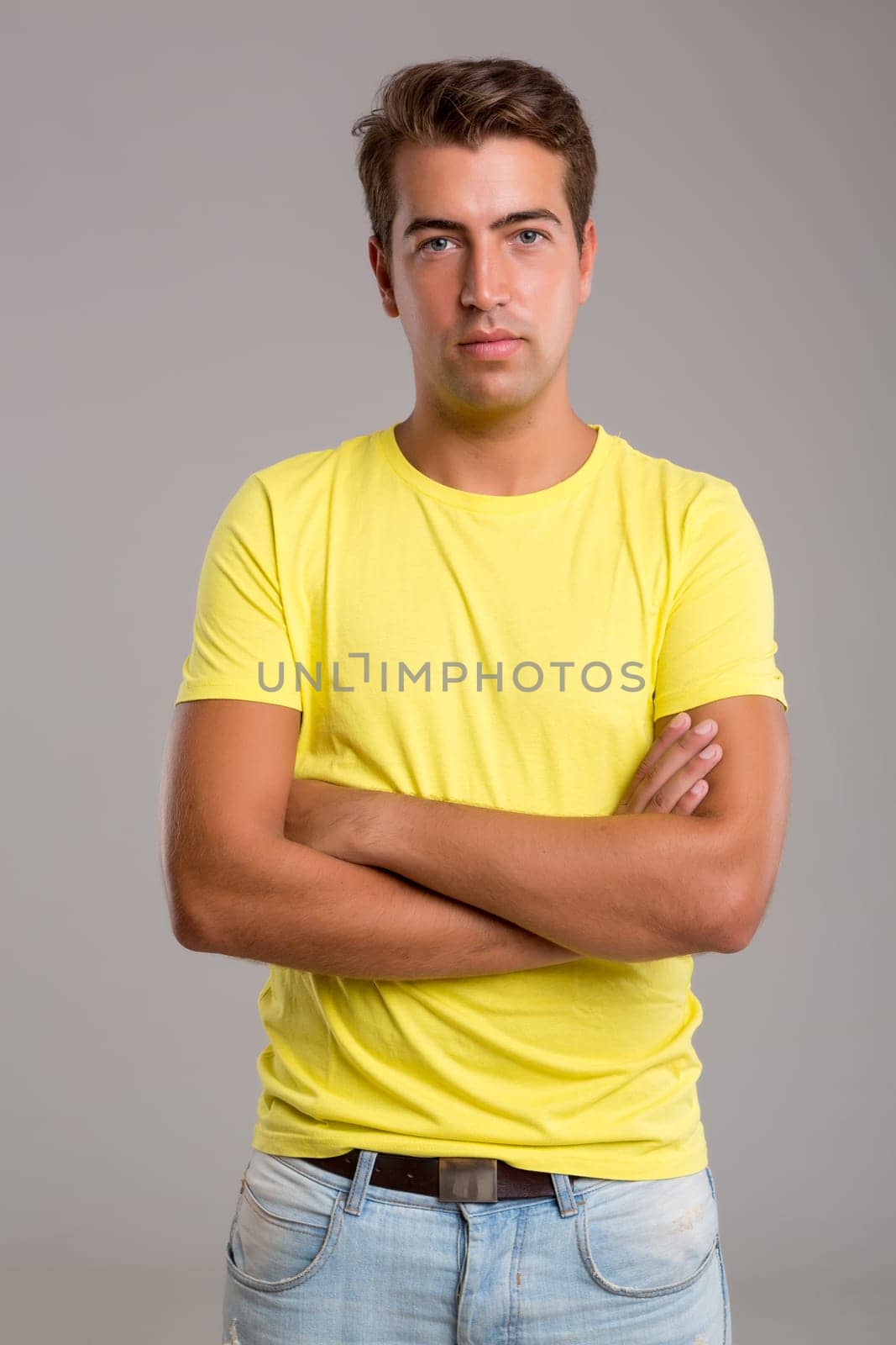 Studio picture of a young and handsome man posing isolated