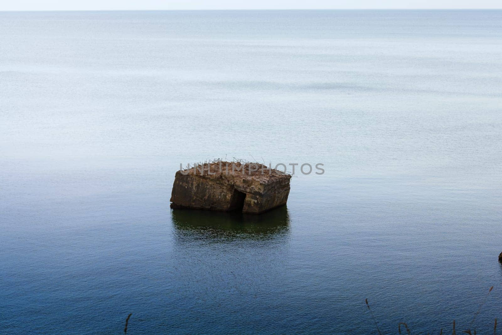 Old German bunker is rinsed out in the sea on the cliffs of the Baltic coast