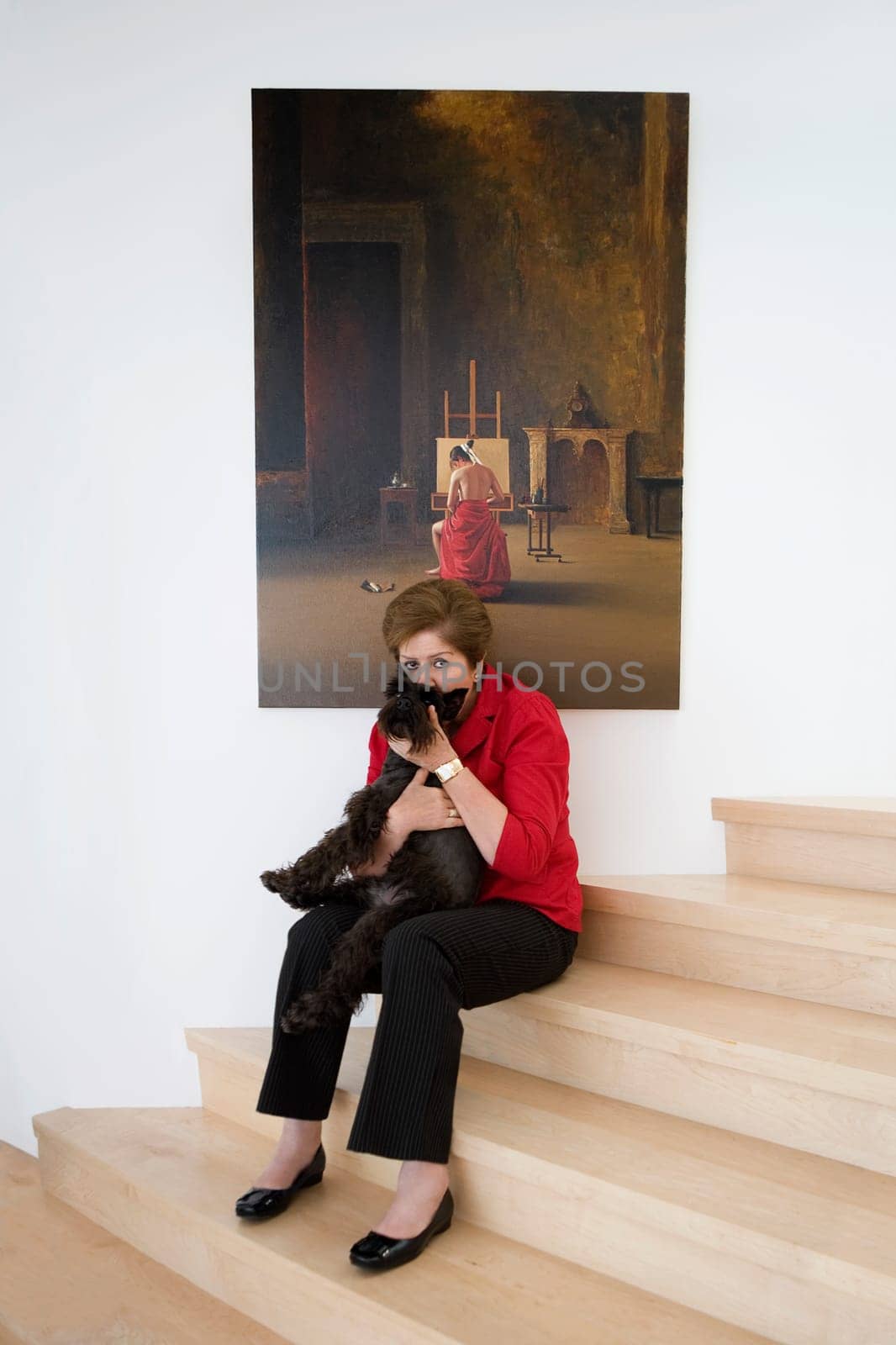 Portrait of a mid adult woman carrying a dog