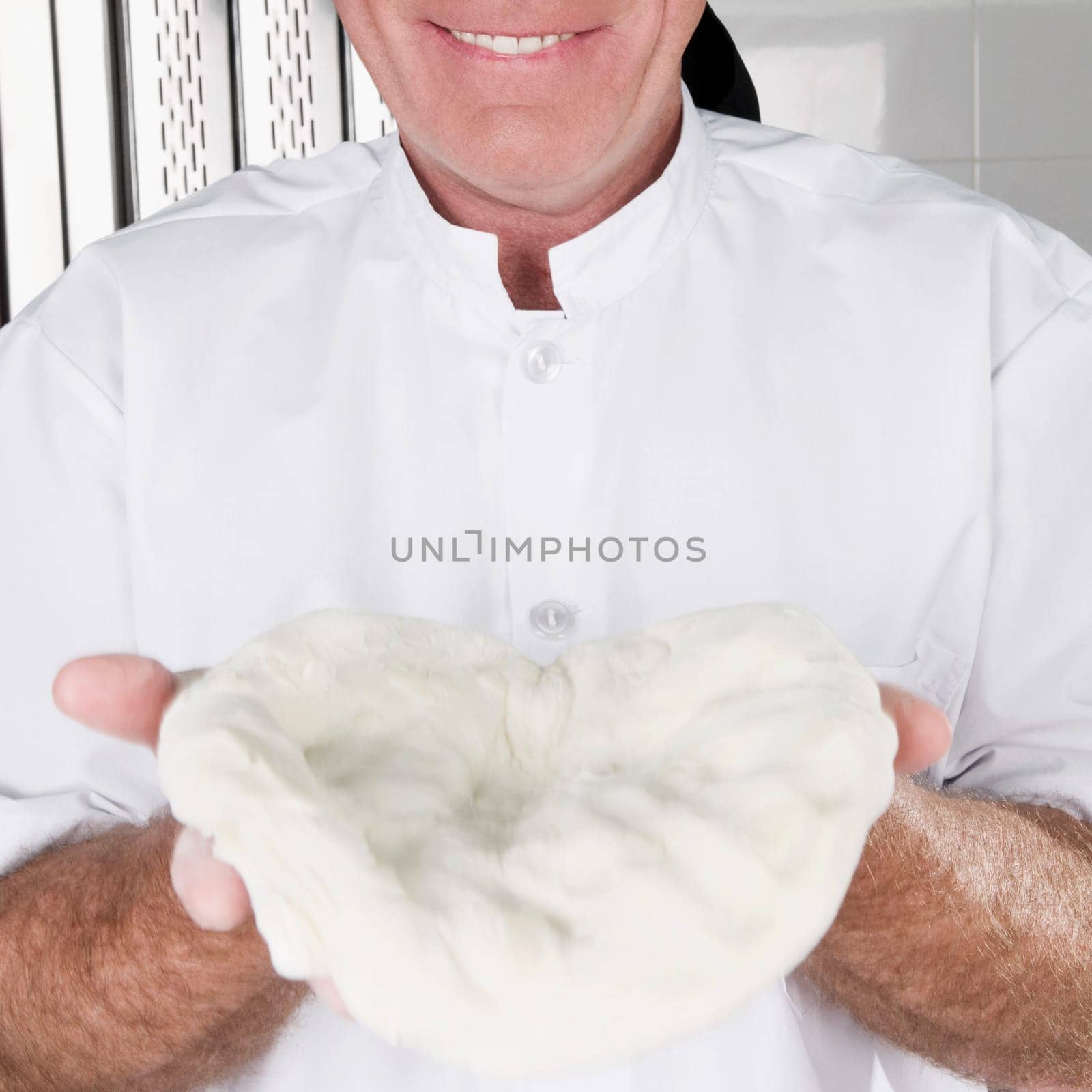 Chef holding pizza dough