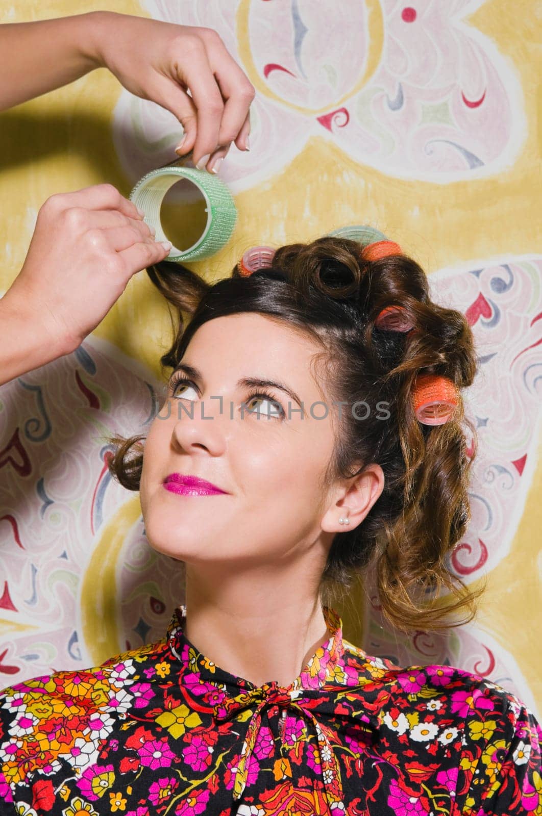 Hairdresser adjusting the hair of a young woman