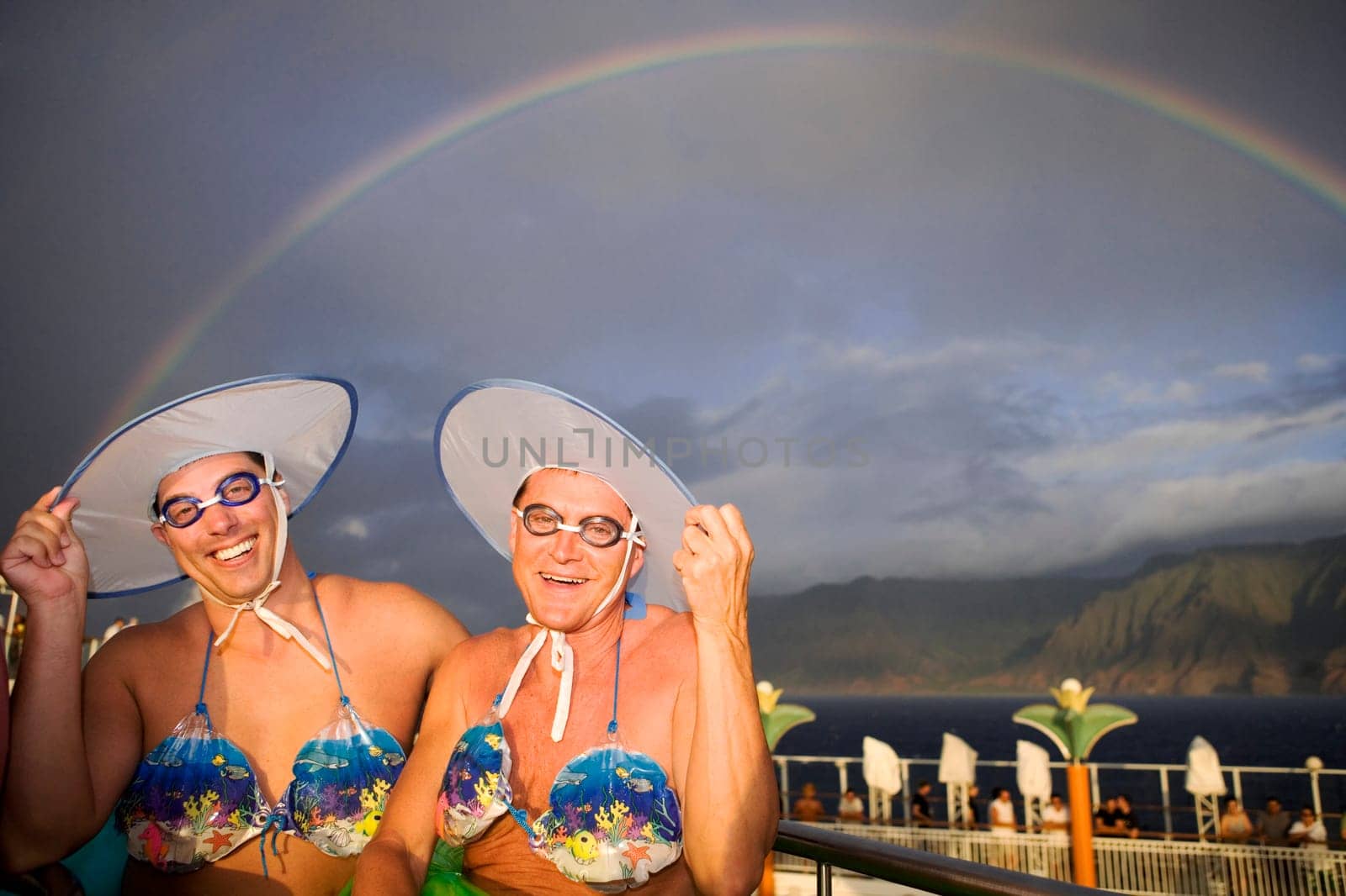 Two gay men wearing bikini tops and dancing