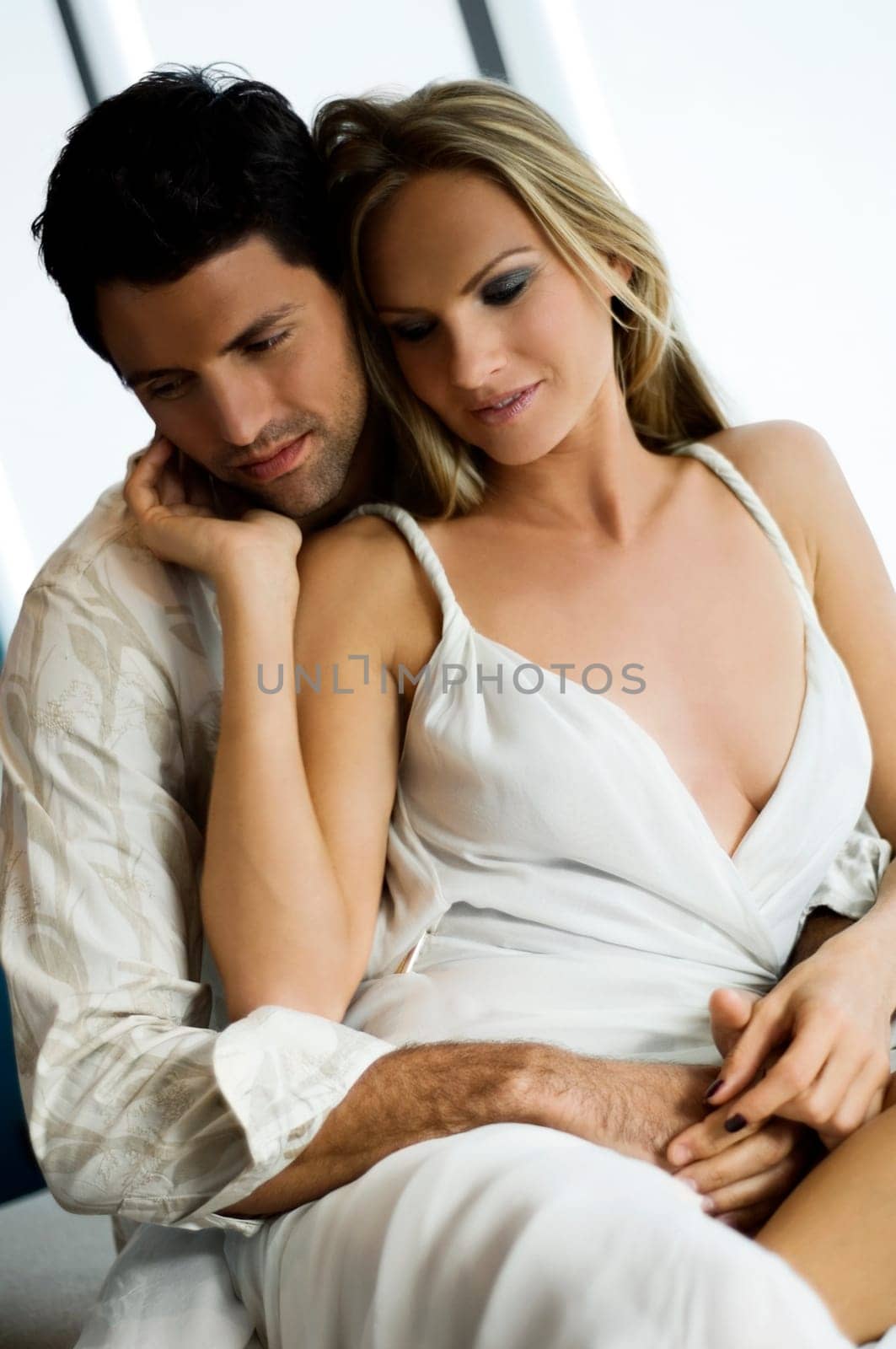 Mid adult man embracing a mid adult woman from behind